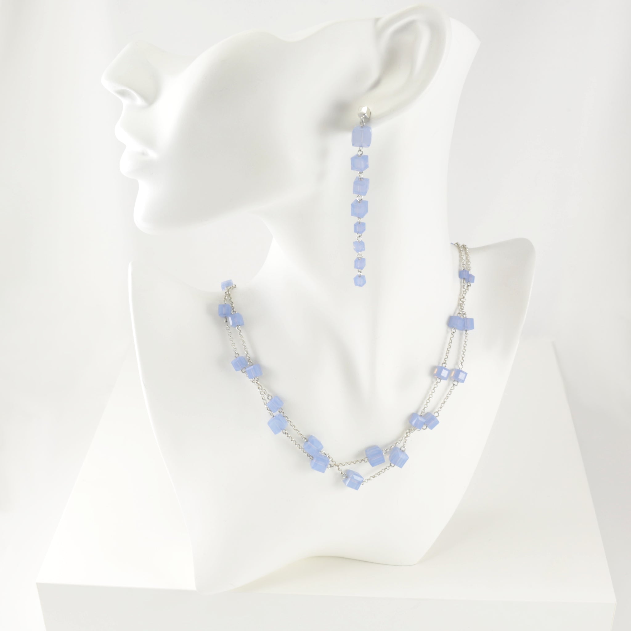 Earrings and necklace set made from sterling silver and Swarovski cube crystals in the color of a powdery, milky, light blue.