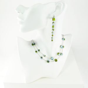 Lightweight earrings and necklace set made with sterling silver and Swarovski crystals in a shiny, iridescent olive color in cube shape.