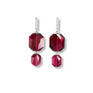 Two emerald cut Swarovski crystals in a rich, ruby red color displayed on a rectangle sterling silver with cubic zirconia ear stud earrings