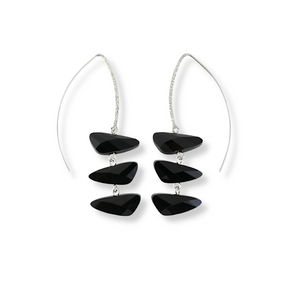 Wing shaped Swarovski crystal earrings in a reflective, jet black color. The three crystal pendant is displayed on a long sterling silver marquise hook 