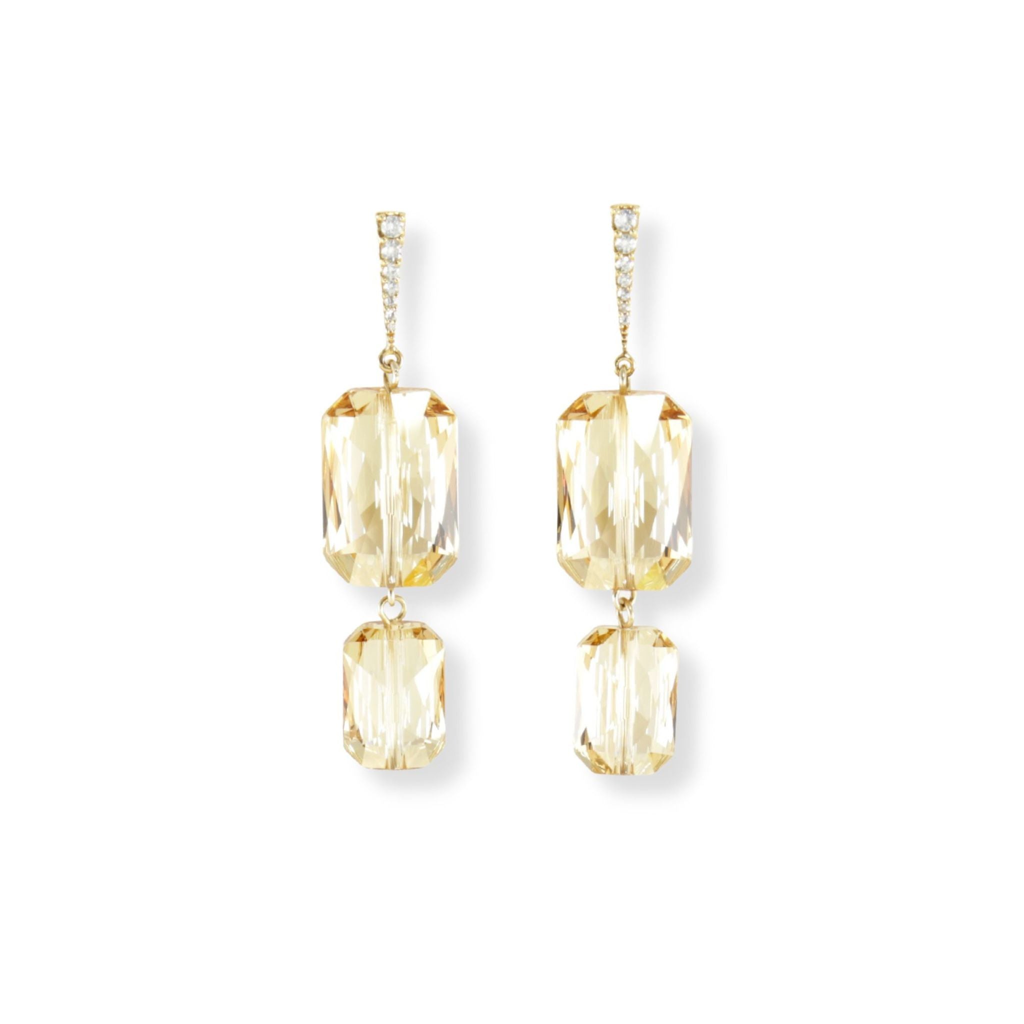 Emerald cut Swarovski crystal pendant earrings in an elegant, light golden color displayed on a cubic zirconia & gold plated silver rectangle ear stud