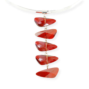Swarovski wing shaped crystal pendant necklace in a reflective deep cognac red color. The five crystal pendant hangs on a removeable and interchangeable silver plated brass torque neck wire