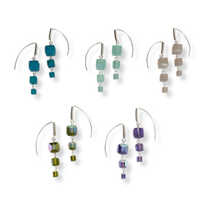 Swarovski crystal cube earrings with long marquise hook. Each earring has three cube shaped crystals, linked together with sterling silver. Color options are turquoise, powdery green opal,  light grey opal, iridescent olive green, and iridescent blueish purple tanzanite. 