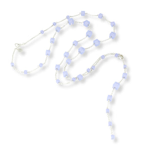 Long, versatile necklace composed of Swarovski crystals in a powdery, milky, light blue color and cube shape. Chain and clasp are sterling silver.