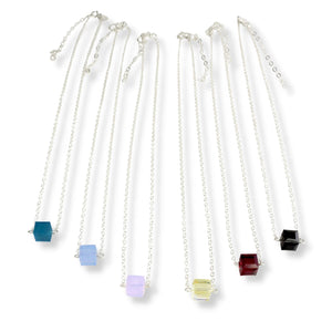 Single cube Swarovski crystal necklace with sterling silver chain, clasp, and extension. Comes in either powdery light blue, rich ruby red, rich teal, dark jet black, or light golden color.